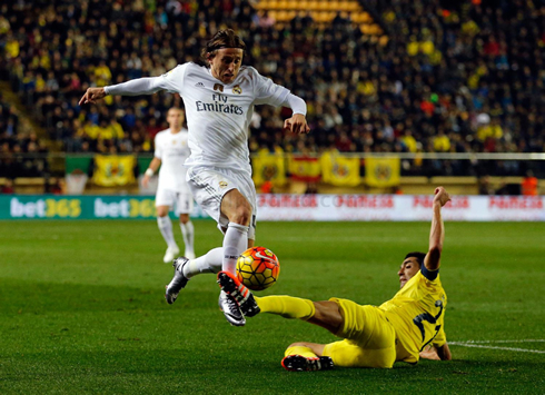 Luka Modric jumping above an opponent's legs