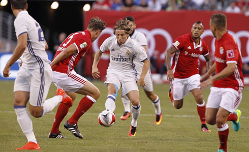 Luka Modric surrounded by Bayern players