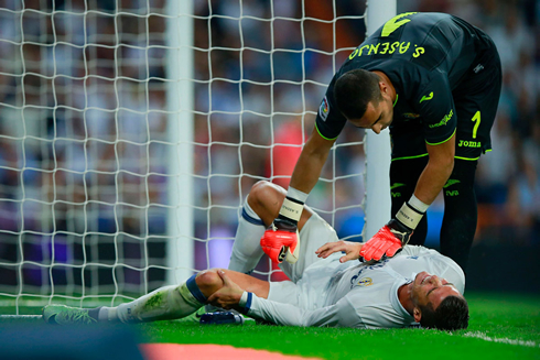 Cristiano Ronaldo hurt on the ground comforted by the goalkeeper