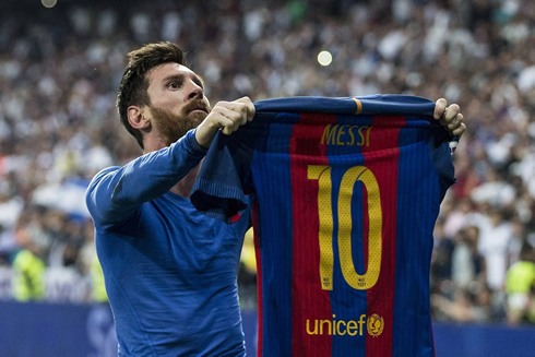 Lionel Messi holds his Barcelona shirt up high after a 3-2 win vs Real Madrid in 2017