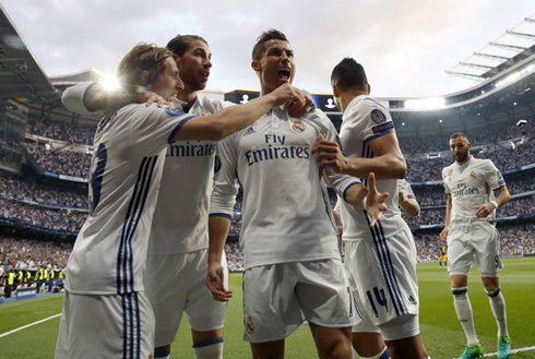 Real Madrid players gather around Ronaldo after a goal