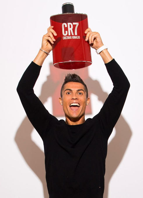 Cristiano Ronaldo holding a giant CR7 fragance bottle