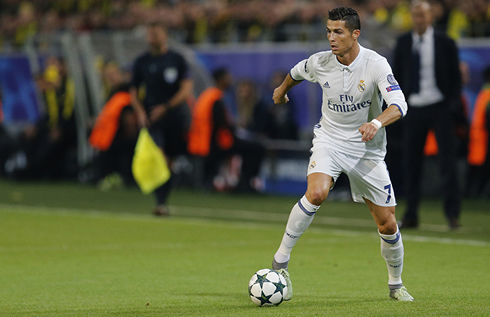 Cristiano Ronaldo moving the ball forward with Zidane watching him from behind