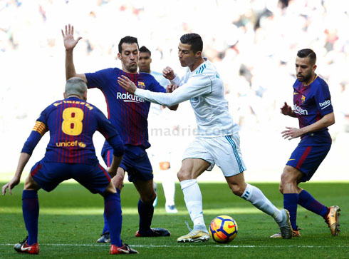 Cristiano Ronaldo surrounded by Barcelona players