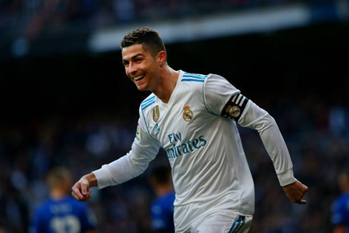 Cristiano Ronaldo bends forward and smiles
