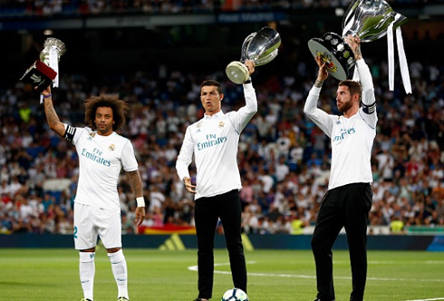 Marcelo, Cristiano Ronaldo and Sergio Ramos holding trophies in Madrid