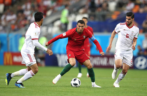 Cristiano Ronaldo surrounded by Iran opponents in World Cup game