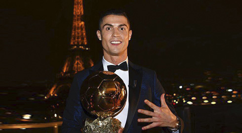 Cristiano Ronaldo holding his fifth Ballon d'Or in Paris in front of the Eiffel Tower