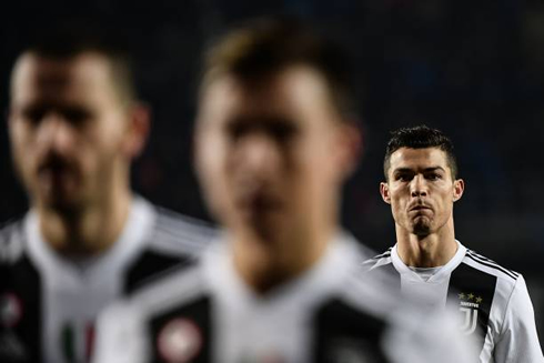 Cristiano Ronaldo looking focused behind his teammates