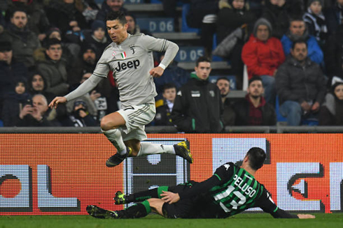 Cristiano Ronaldo jumping over an opponent on the ground