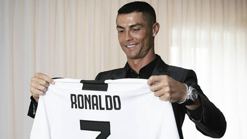 Cristiano Ronaldo holding his new Juventus shirt