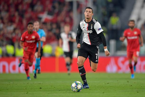 Cristiano Ronaldo sprinting during a Champions League game for Juventus
