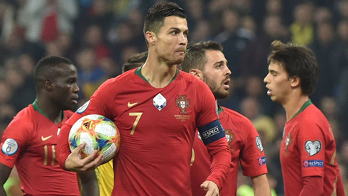 Cristiano Ronaldo grabs the match ball after scoring 700 goals in his career