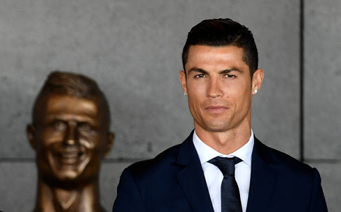 Cristiano Ronaldo next to his bust