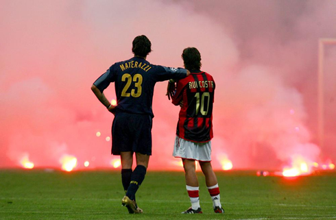 Football passion from the fans while Materazzi and Rui Costa contemplate the fire
