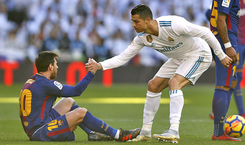 Cristiano Ronaldo helping Lionel Messi standing up