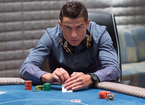 Cristiano Ronaldo hiding his cards on a poker table