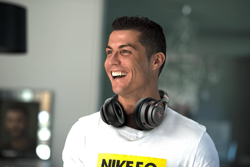 Cristiano Ronaldo laughing with his headphones around his neck