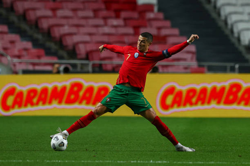 Cristiano Ronaldo stretches to control the ball on the ground