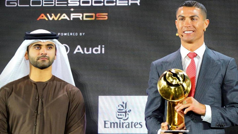 Cristiano Ronaldo posing for a photo with the Player of the Century award in his hands