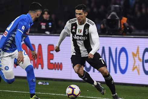 Cristiano Ronaldo taking on a defender in Juventus vs Napoli