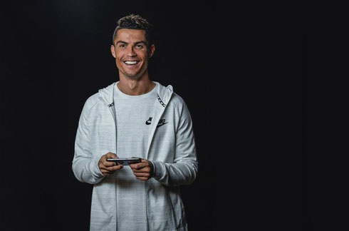 Cristiano Ronaldo holding a smartphone