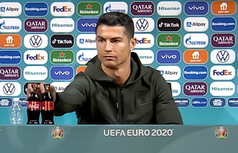 Cristiano Ronaldo moving away Coca-Cola bottles in a press conference