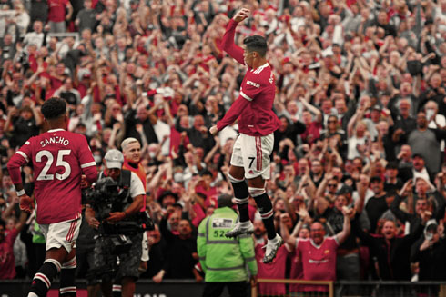 Cristiano Ronaldo jumping to celebrate his goal with United fans