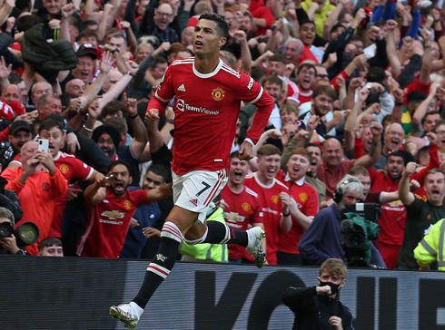 Cristiano Ronaldo running in front of Old Trafford crowd