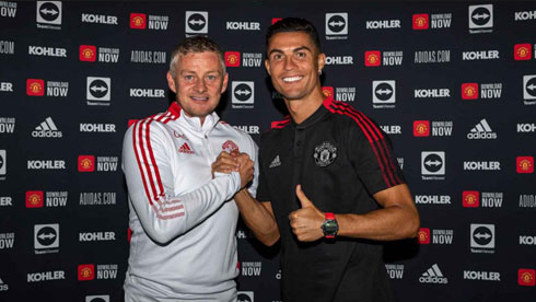 Cristiano Ronaldo taking a photo next to Solskjaer