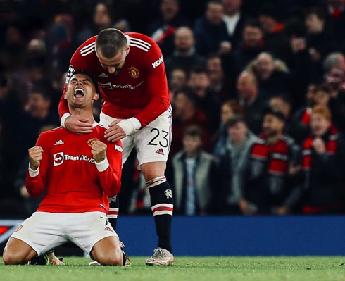 Shaw hugging Cristiano Ronaldo from behind