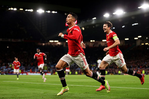 Cristiano Ronaldo runs across the pitch with teammates following him