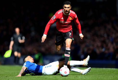 Cristiano Ronaldo jumping over a defenders legs