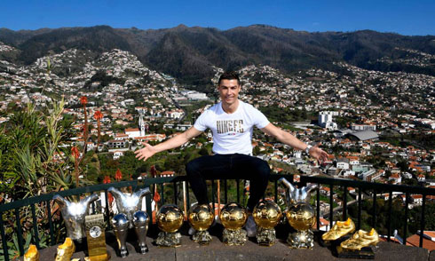 Cristiano Ronaldo showing off his trophies with Madeira on the background