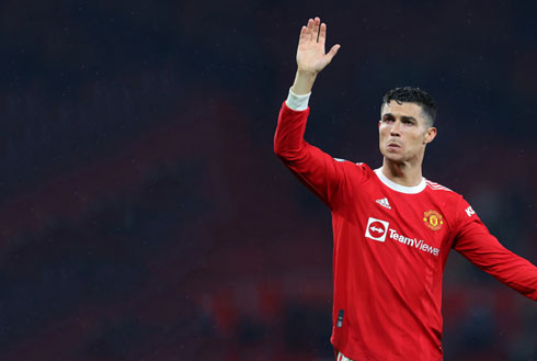 Cristiano Ronaldo waves at fans during a game for United