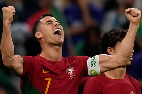 Cristiano Ronaldo rasising his arms in the air to celebrate goal at the 2022 World Cup