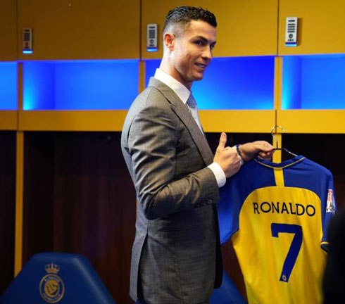 Cristiano Ronaldo holding his new Al-Nassr shirt