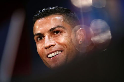 Cristiano Ronaldo smiling behind the cameras