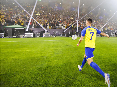 Cristiano Ronaldo kicking the ball to the fans in the stands