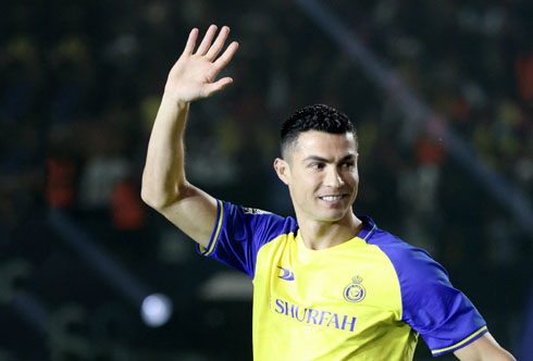 Cristiano Ronaldo waves his hand at fans in Saudi Arabia