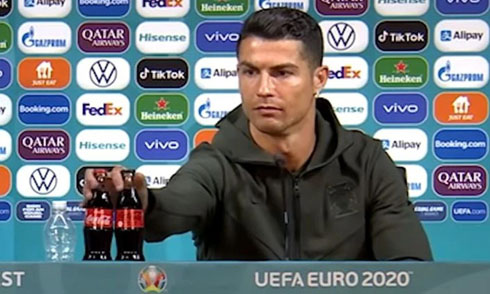 Cristiano Ronaldo displacing two Coca Cola cans in a TV press conference
