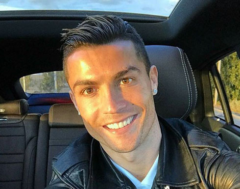 Cristiano Ronaldo smiling to his phone camera in his car