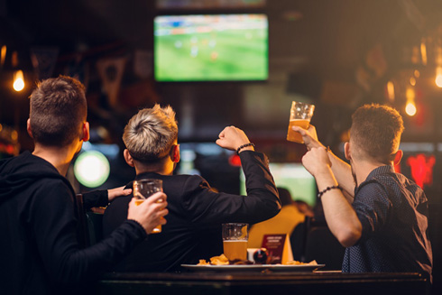 Football fans enjoying a game in a bar