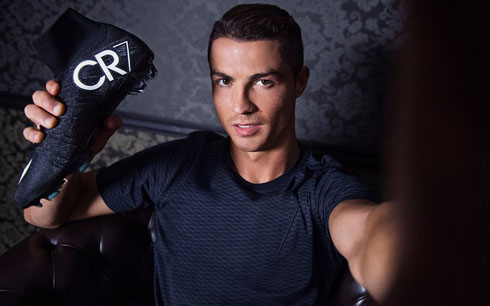 Cristiano Ronaldo holding his CR7 boot to the camera