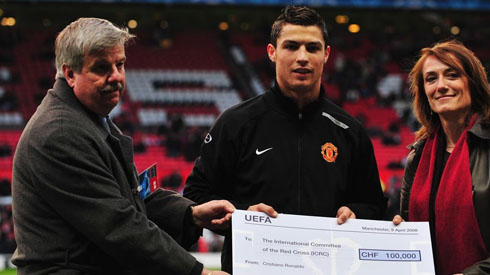 Cristiano Ronaldo holding a charity paycheck in Manchester