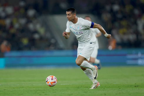 Cristiano Ronaldo in a full sprint in a white kit for Al Nassr