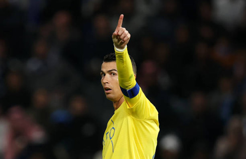 Cristiano Ronaldo pointing his finger to the side at Al Nassr