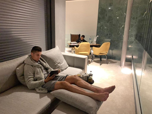 Cristiano Ronaldo relaxing in the couch and reading a book
