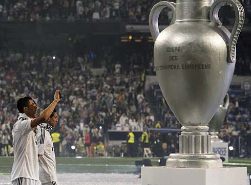 Cristiano Ronaldo on the background of the Champions League trophy
