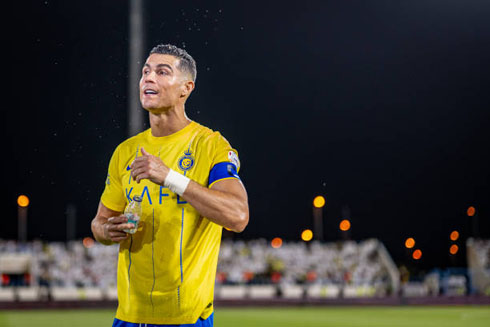 Cristiano Ronaldo holding a bottle in a football game